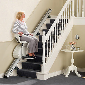 Elderly Woman using a Straight Stairlift in her home